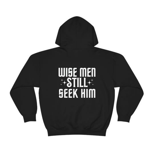 A Wise Men Still Seek Him hoodie in black with white text. Unisex heavy blend, cotton-polyester fabric, kangaroo pocket, and drawstring hood. Classic fit, tear-away label, medium-heavy fabric.