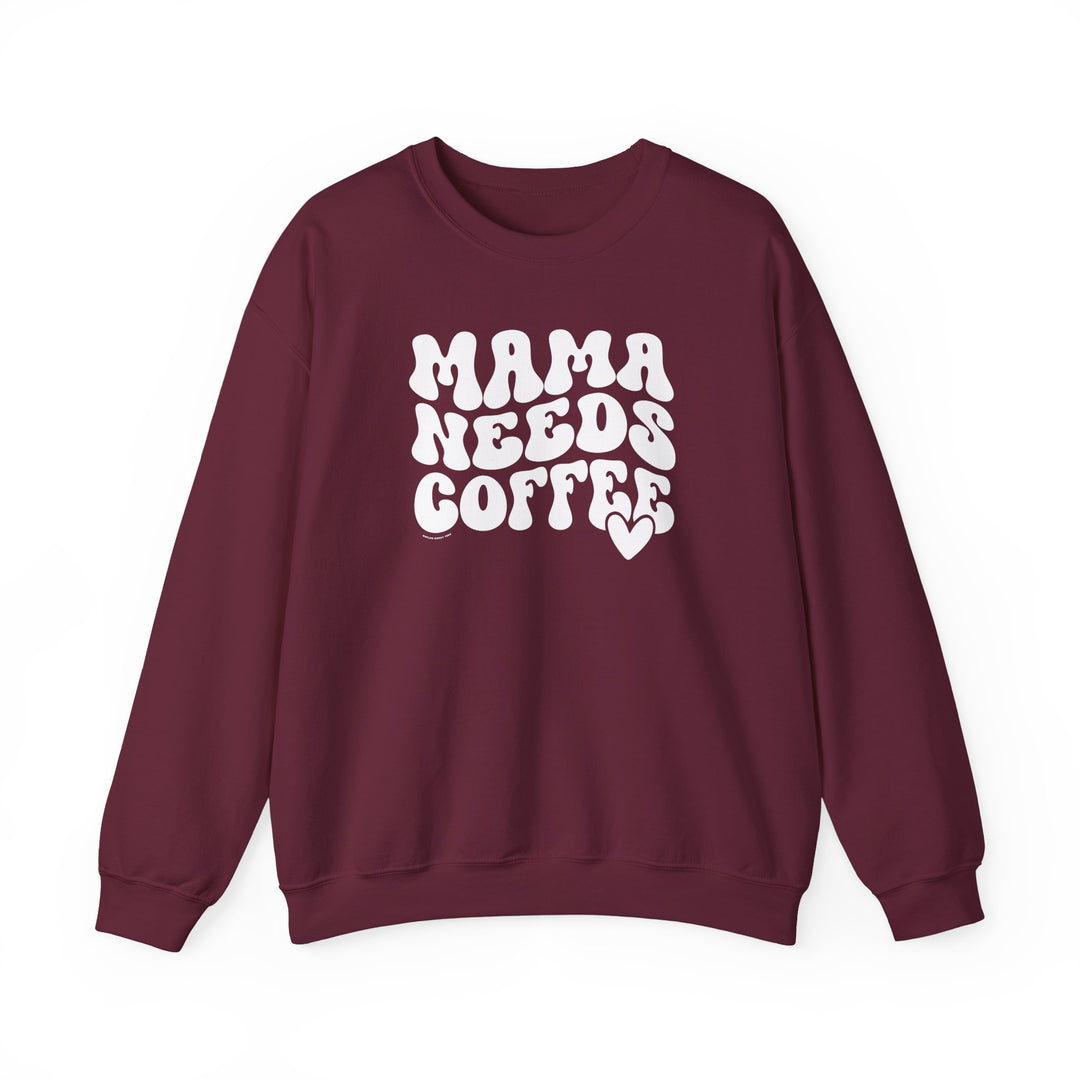 Unisex Mama Needs Coffee Crew sweatshirt, maroon with white text. Heavy blend fabric, ribbed knit collar, no itchy seams. 50% cotton, 50% polyester, loose fit, true to size. Sizes S-5XL.
