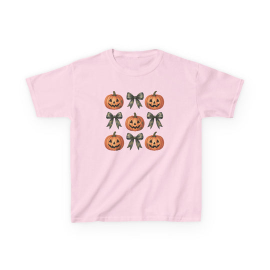 Jack and Bow Kids Tee in light pink, featuring a playful 3x3 pattern of carved jack-o’-lanterns and dark green ribbon bows, perfect for everyday wear.