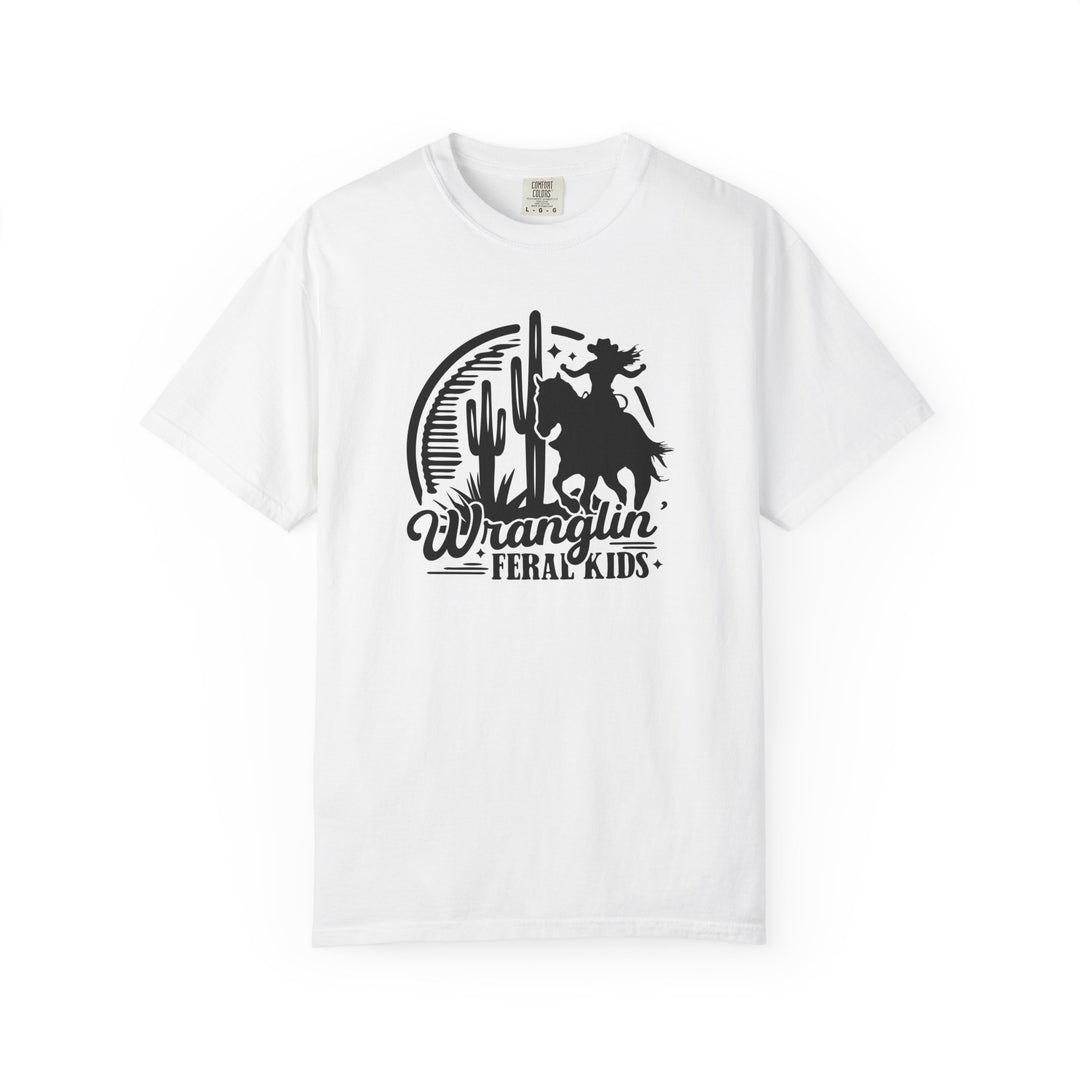 White crew-neck tee with black western graphic of a rider, cacti, and crescent moon, captioned Wranglin’ Feral Kids. Durable, relaxed fit, made from soft-washed cotton.