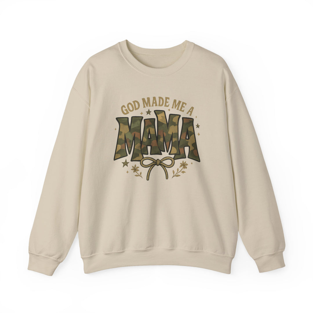 Cream-colored crewneck sweatshirt with GOD MADE ME A MAMA graphic; MAMA in camouflage pattern, accented by a bow, stars, and floral sprigs.