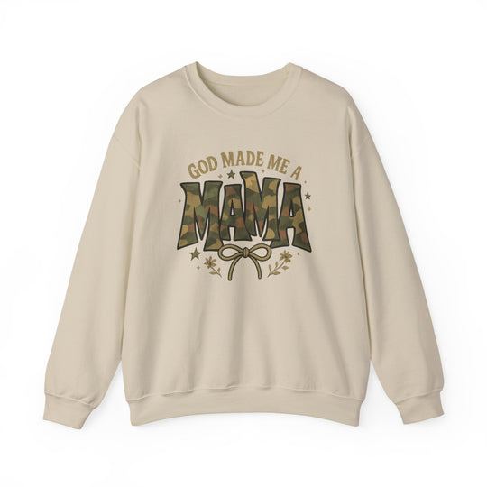 Cream-colored crewneck sweatshirt with GOD MADE ME A MAMA graphic; MAMA in camouflage pattern, accented by a bow, stars, and floral sprigs.
