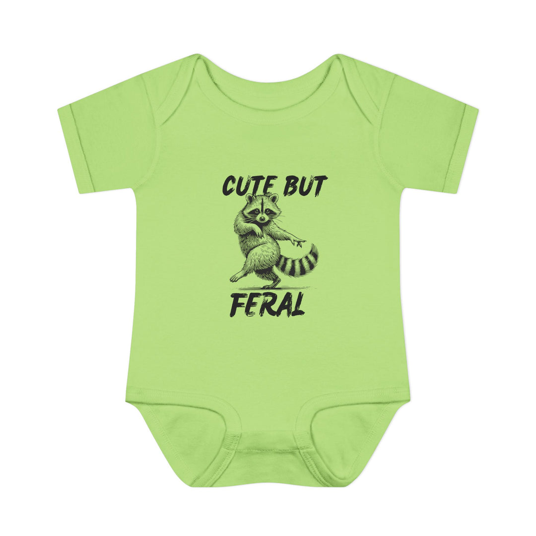 Light-green Cute But Feral onesie featuring a playful raccoon illustration, crafted from soft, 100% combed ring-spun cotton, ideal for infants' comfort and ease.