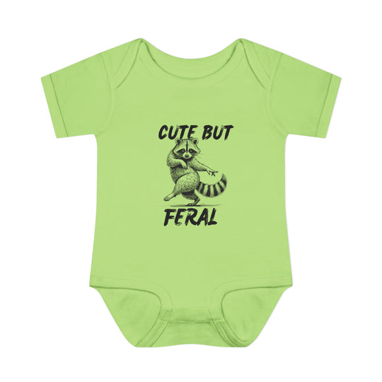 Light-green Cute But Feral onesie featuring a playful raccoon illustration, crafted from soft, 100% combed ring-spun cotton, ideal for infants' comfort and ease.