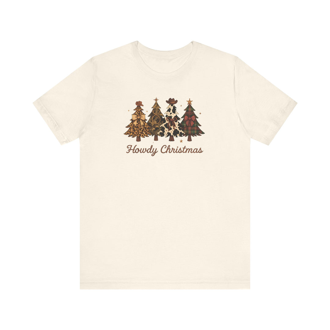 Cream-colored Howdy Christmas tee featuring four stylized Christmas trees with western motifs and cowboy hats. Unisex fit, soft cotton, and durable design.