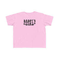 A Daddy's Girl Toddler Tee in pink with black text, ideal for sensitive skin. Made of 100% combed ringspun cotton, light fabric, classic fit, tear-away label, and true-to-size. Perfect for first ventures.