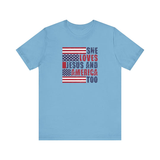 Unisex She Loves Jesus and America Tee: A classic blue t-shirt with red and blue text. 100% cotton, ribbed knit collars, tear away label. Sizes XS-3XL. Soft, durable, and stylish.