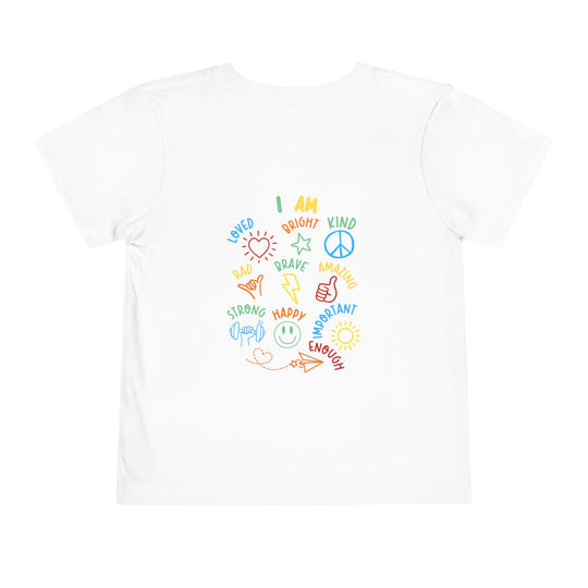 I AM Toddler Tee featuring colorful affirmations and doodles encircling I AM on a plain white T-shirt, perfect for inspiring positivity in kids.