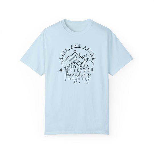 A light blue Rise and Shine Tee with a graphic design featuring a cross and mountains. Made of 100% ring-spun cotton, medium weight, and relaxed fit for everyday comfort.