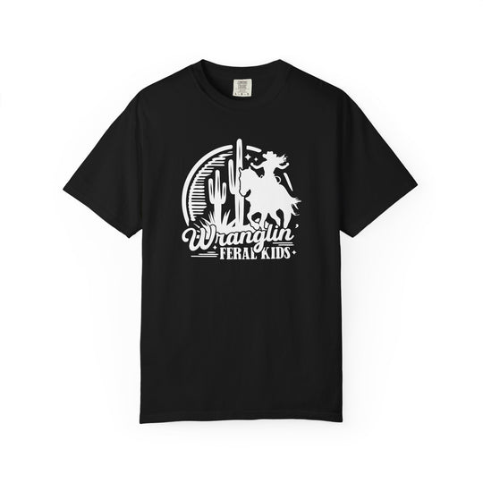 Black Wranglin' Feral Kids Tee featuring a cowboy on a horse against a desert backdrop with cacti, perfect for casual wear with a humorous twist.