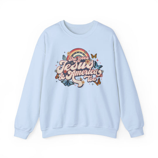 A unisex heavy blend crewneck sweatshirt featuring a graphic design of butterflies and flowers, titled She Loves Jesus and America Crew. Made of 50% Cotton 50% Polyester, ribbed knit collar, no itchy side seams, loose fit. Medium-heavy fabric.