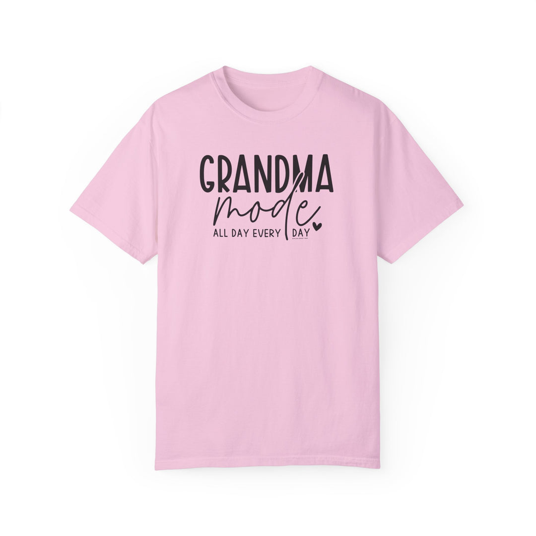A Grandma Mode Tee, a pink shirt with black text, 100% ring-spun cotton, medium weight, relaxed fit, durable double-needle stitching, seamless design for comfort and style.
