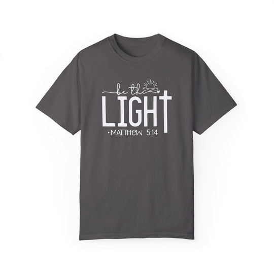 A grey t-shirt featuring white Be the Light text. Made of 100% ring-spun cotton, garment-dyed for extra coziness. Relaxed fit, durable double-needle stitching, and tubular shape. From Worlds Worst Tees.