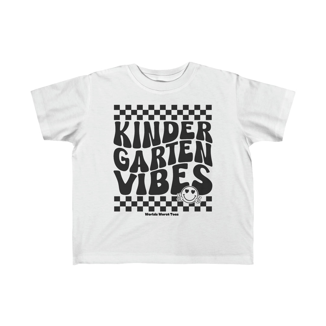 A Kindergarten Vibes Toddler Tee featuring black text on a white shirt. Made of 100% combed ringspun cotton, light fabric, classic fit, tear-away label, perfect for sensitive skin.