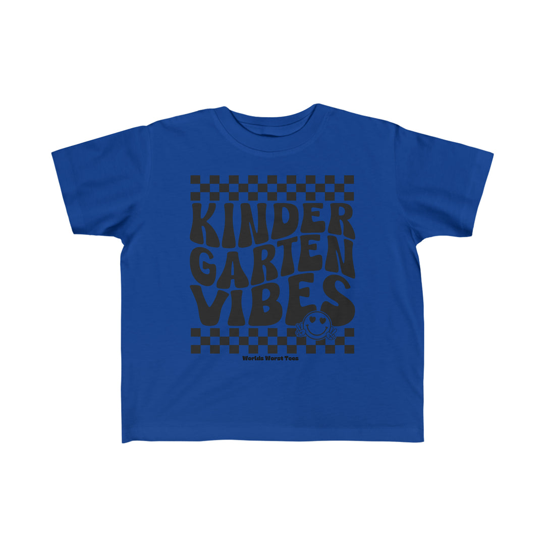 A Kindergarten Vibes Toddler Tee featuring black text on a blue shirt. Made of 100% combed ringspun cotton, light fabric, classic fit, tear-away label, perfect for sensitive skin.