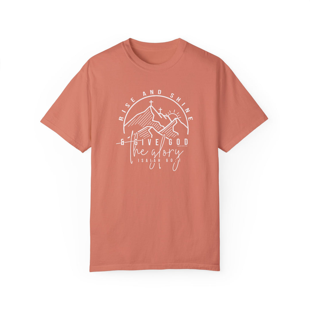 A relaxed fit Rise and Shine Tee in red with white text, crafted from 100% ring-spun cotton. Garment-dyed for coziness, featuring double-needle stitching for durability and a seamless design for a tubular shape.