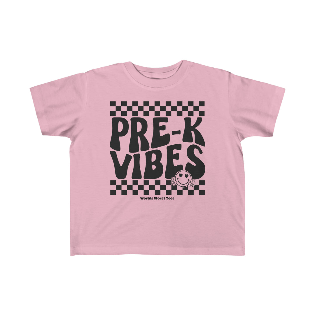 A Pre K Vibes Toddler Tee featuring black text on a pink shirt. Made of 100% combed ringspun cotton, light fabric, classic fit, and tear-away label. Ideal for toddlers.