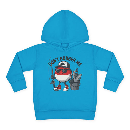 Don't Bobber Me Toddler Hoodie featuring a cartoon bobber character with sunglasses and fishing gear, emphasizing comfort and durability with side-seam pockets and a jersey-lined hood.