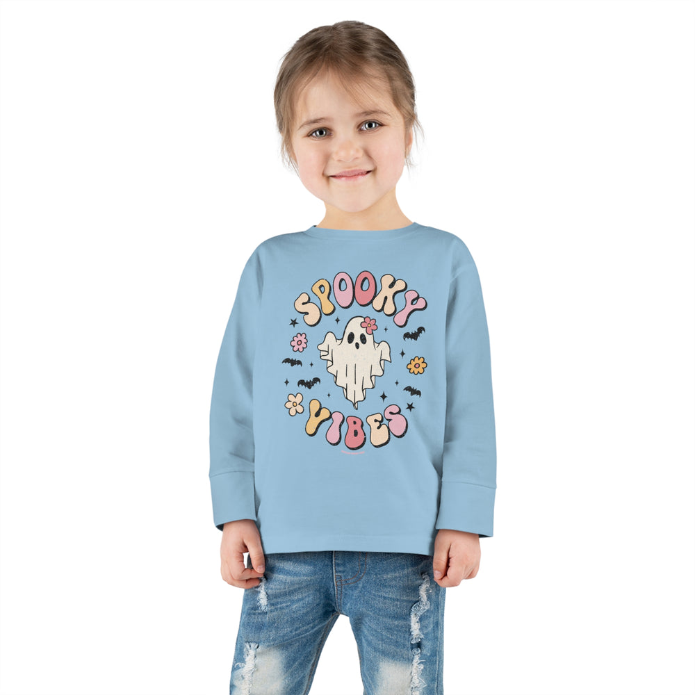 A spooky vibes toddler long sleeve tee featuring a ghost and bats design on a blue shirt. Made from 100% combed ringspun cotton, with topstitched ribbed collar for durability and EasyTear™ label for sensitive skin.