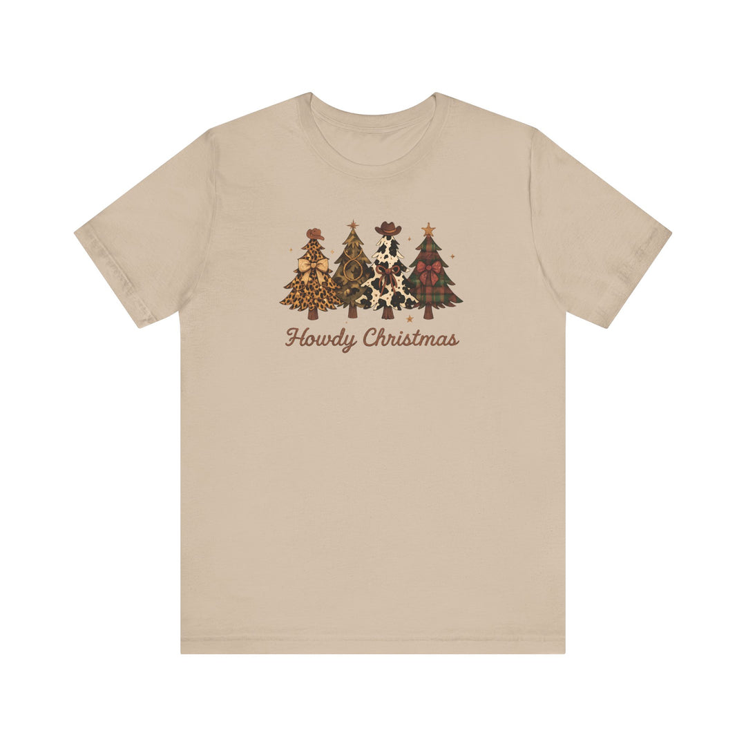 Howdy Christmas Tee with four Western-themed Christmas trees and rustic script on a light tan T-shirt, showcasing unique patterns like leopard and cow prints.