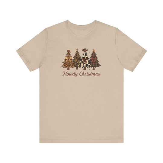 Howdy Christmas Tee with four Western-themed Christmas trees and rustic script on a light tan T-shirt, showcasing unique patterns like leopard and cow prints.