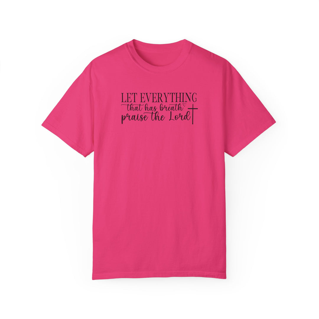 Relaxed fit Let Everything That Has Breath Praise the Lord Tee. Pink shirt with black text. 100% ring-spun cotton, garment-dyed for coziness. Durable double-needle stitching, no side-seams for tubular shape.