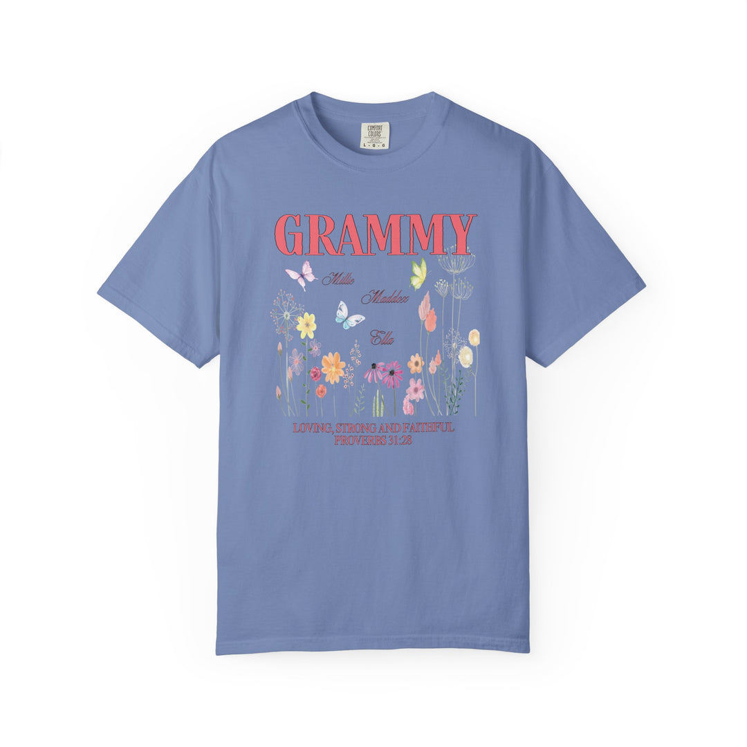 Grammy Tee featuring a vibrant floral and butterfly design on a blue background, crafted from soft, durable, 100% ring-spun cotton for lasting comfort.