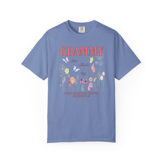 Grammy Tee featuring a vibrant floral and butterfly design on a blue background, crafted from soft, durable, 100% ring-spun cotton for lasting comfort.