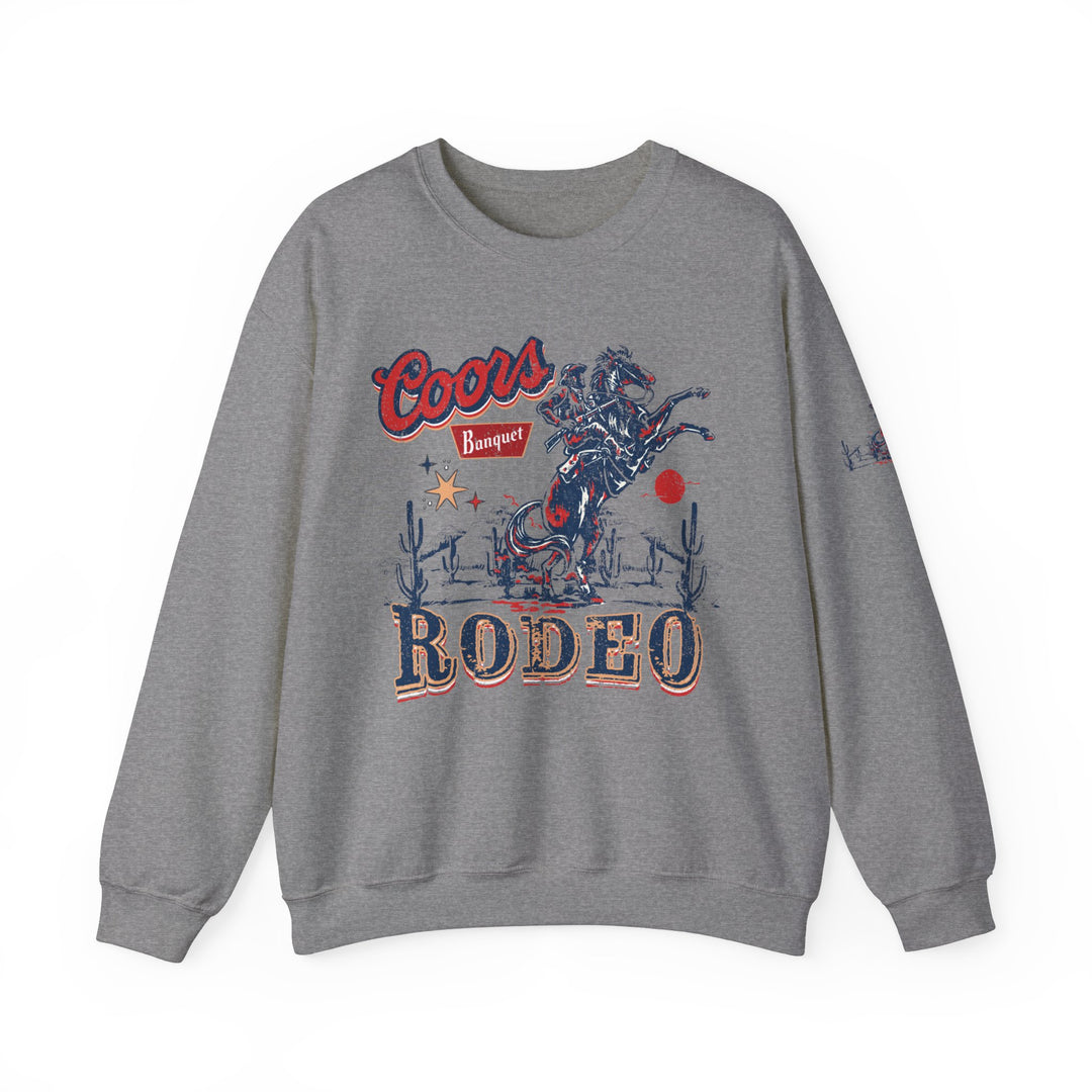 A grey Coors Rodeo Crew sweatshirt with a cowboy graphic, ribbed knit collar, and no itchy side seams. Unisex heavy blend for comfort, 50% Cotton 50% Polyester, loose fit, medium-heavy fabric.