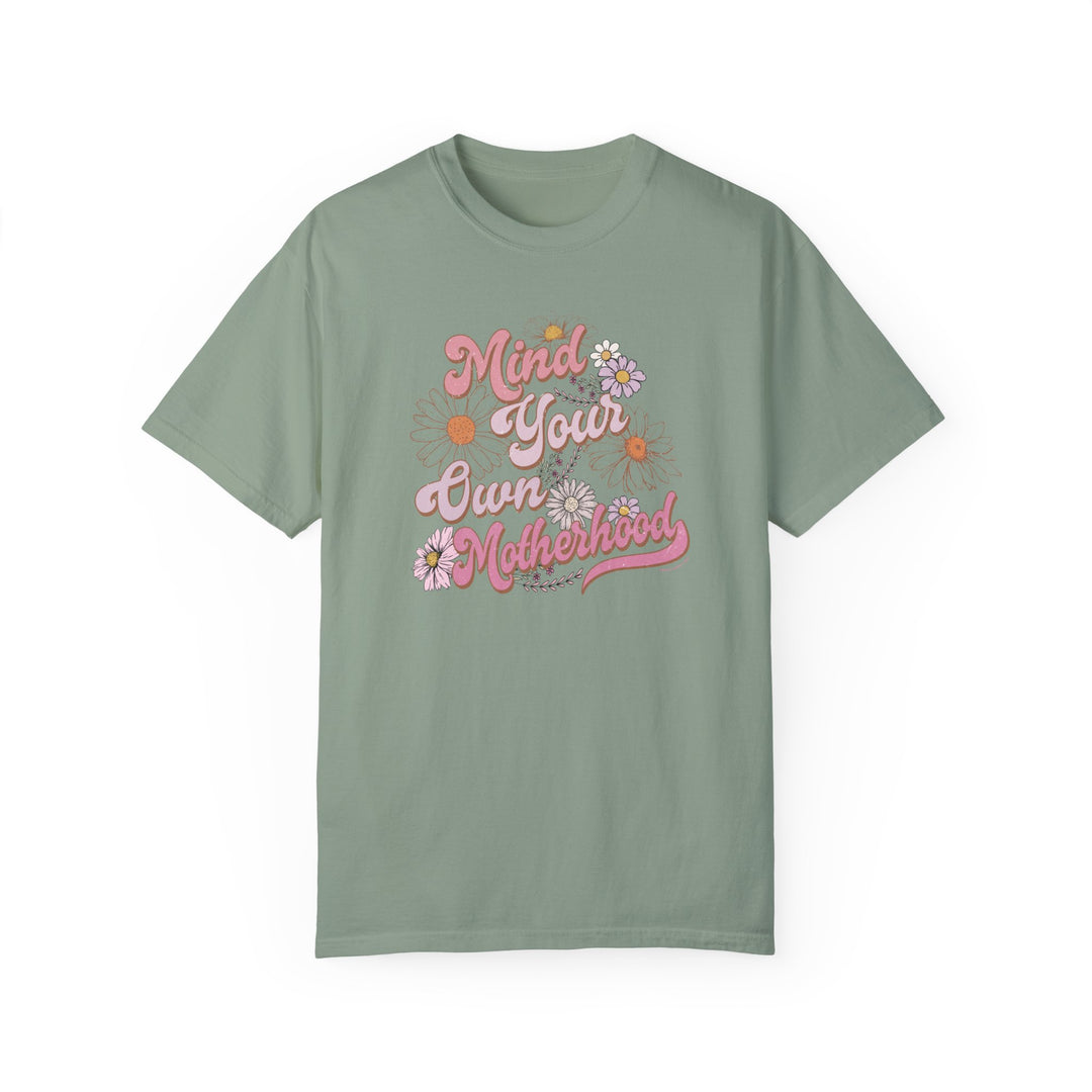 A relaxed fit Mind Your Motherhood Tee, garment-dyed for extra coziness. Made of 100% ring-spun cotton with double-needle stitching for durability. Ideal for daily wear.