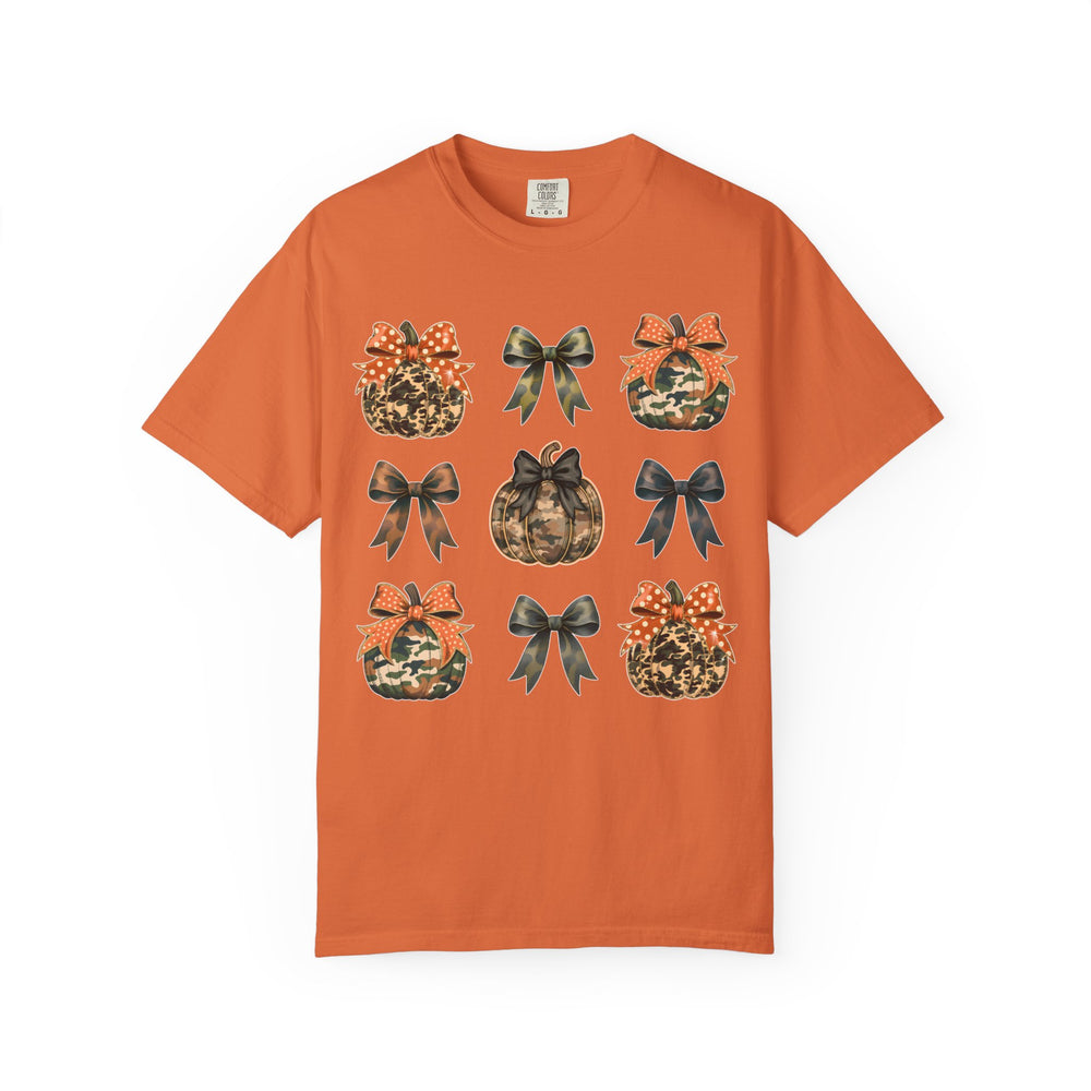 Bows and Pumpkins Tee features a 3x3 grid of camouflage-patterned pumpkins and bows on an orange short-sleeve crew-neck t-shirt, emphasizing fall-themed graphics.