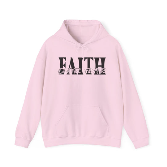 A cozy Faith Over Fear Hoodie, featuring black text on a pink sweatshirt. Unisex heavy blend, cotton-polyester fabric for warmth. Kangaroo pocket and matching drawstring for style and practicality.