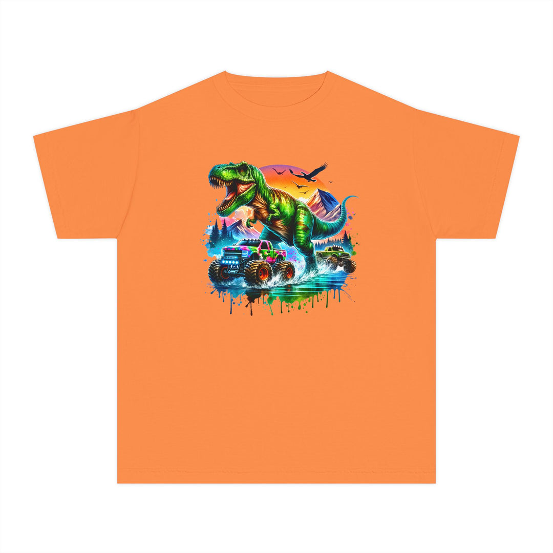 Dino Truck Kids Tee: An orange youth T-shirt showcasing a roaring T-rex with monster trucks, set against a vibrant sky and a dynamic, graffiti-style design.