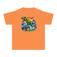 Dino Truck Kids Tee: An orange youth T-shirt showcasing a roaring T-rex with monster trucks, set against a vibrant sky and a dynamic, graffiti-style design.