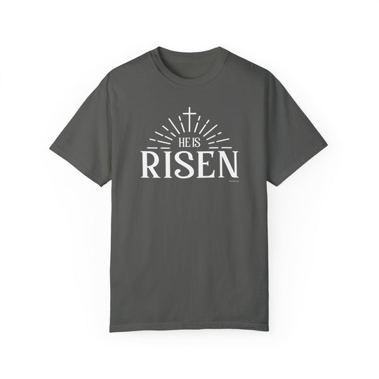 Relaxed fit He is Risen Tee, grey t-shirt with white text. 100% ring-spun cotton, garment-dyed for coziness. Durable double-needle stitching, no side-seams for a tubular shape.