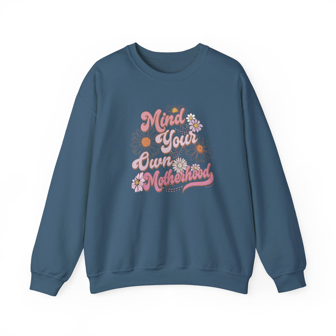 Unisex Mind Your Own Motherhood Crew sweatshirt, featuring a graphic design of pink flowers and words. Made of 50% cotton and 50% polyester blend, ribbed knit collar, and a loose fit. Sizes S to 5XL.