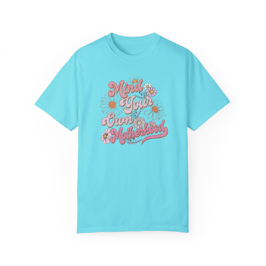 Mind Your Motherhood Tee: A blue t-shirt with pink text, made of 100% ring-spun cotton for a cozy feel. Relaxed fit, double-needle stitching, and no side-seams for durability and shape retention.