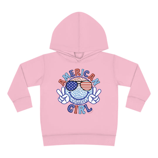 American Girl Toddler Hoodie featuring a pink hoodie with a smiley face wearing sunglasses. Designed for comfort with jersey-lined hood, cover-stitched details, and side seam pockets. Ideal for toddlers.