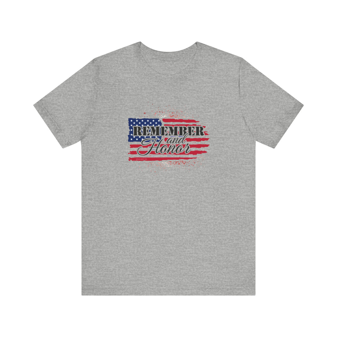 A grey t-shirt featuring a flag and text, the Remember and Honor Tee from Worlds Worst Tees. Unisex jersey tee with ribbed knit collar, 100% Airlume combed cotton, and retail fit.
