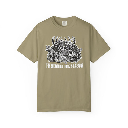 For Everything There is a Season Tee features a black-and-white game animal collage on khaki, highlighting a whitetail buck, fox, duck, and fish.