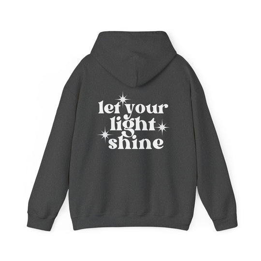 Let Your Light Shine Hoodie: A grey sweatshirt with white text and star symbol. Unisex heavy blend, cotton-polyester fabric for warmth and comfort. Features kangaroo pocket and matching drawstring hood.