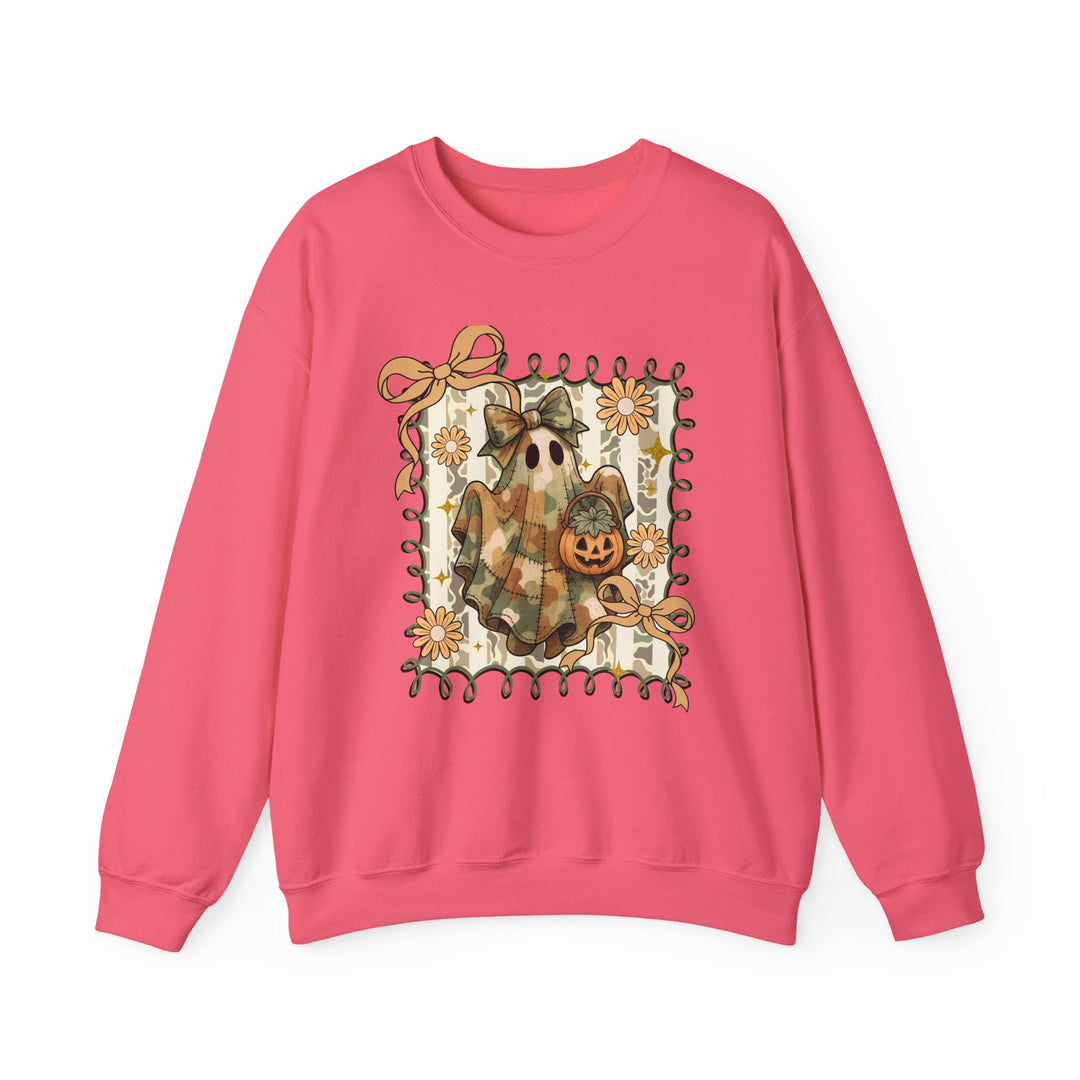 Bright pink crewneck sweatshirt featuring a whimsical camo-patch ghost with a bow, jack-o’-lantern, and floral vine frame, perfect for cozy fall wear.
