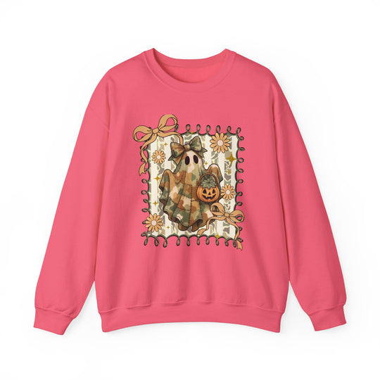 Bright pink crewneck sweatshirt featuring a whimsical camo-patch ghost with a bow, jack-o’-lantern, and floral vine frame, perfect for cozy fall wear.