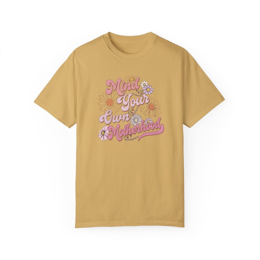 Mind Your Motherhood Tee: A relaxed-fit t-shirt in yellow with pink text, made of 100% ring-spun cotton for ultimate comfort. Double-needle stitching ensures durability. From 'Worlds Worst Tees'.