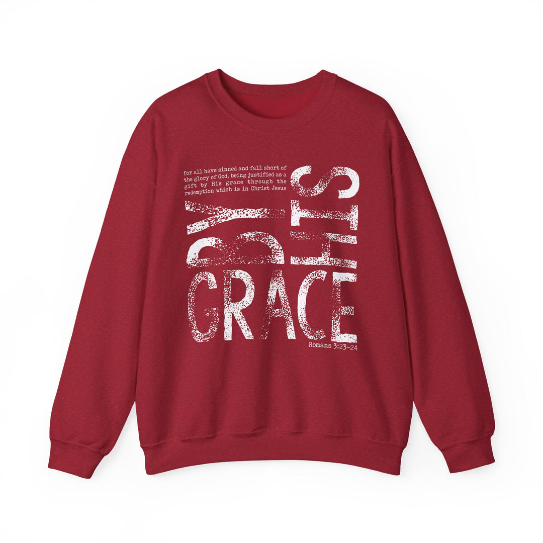 Maroon crew-neck sweatshirt with By His Grace and Romans 3:23-24 scripture in distressed white font, offering comfort and style.