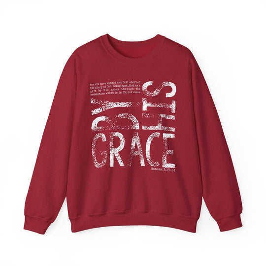Maroon crew-neck sweatshirt with By His Grace and Romans 3:23-24 scripture in distressed white font, offering comfort and style.
