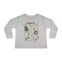 A durable Jesus is Christmas Toddler Long Sleeve Tee made of 100% combed ringspun cotton, featuring ribbed collar and EasyTear™ label for sensitive skin. Unisex fit for toddlers.