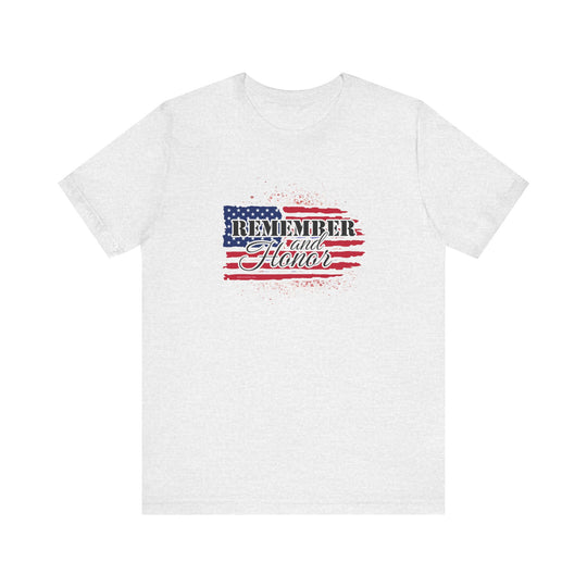 A white t-shirt featuring a flag and text, the Remember and Honor Tee from Worlds Worst Tees. Unisex jersey tee with ribbed knit collars, taping on shoulders, and 100% Airlume combed cotton. Sizes XS to 3XL.