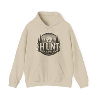 A beige Hunt Life Hoodie with a deer and tree logo on a cotton-polyester blend. Features kangaroo pocket, drawstring hood, and tear-away label. Medium-heavy fabric for comfort and warmth.