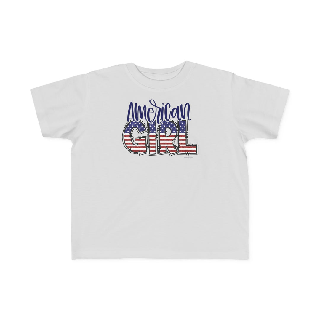 American Girl Toddler Tee featuring a flag design and text on white fabric. 100% combed ringspun cotton, light fabric, classic fit. Sizes: 2T, 3T, 4T, 5-6T. Durable, soft for sensitive skin.